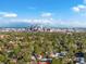 Stunning aerial view of the city skyline, green trees, and neighborhood homes under a blue sky at 4495 Utica St, Denver, CO 80212