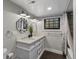 Bathroom with double vanity sinks, neutral walls, and updated lighting at 4495 Utica St, Denver, CO 80212