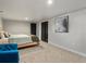 Comfortable bedroom with gray wall paint, black closet doors, and decor at 4495 Utica St, Denver, CO 80212