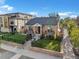 Charming brick home with a manicured lawn, black fencing, and professional landscaping at 4495 Utica St, Denver, CO 80212