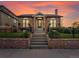 Brick home featuring arched windows, a chimney and professional landscaping at 4495 Utica St, Denver, CO 80212