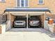 Attached two-car garage with modern vehicles parked inside at 4495 Utica St, Denver, CO 80212