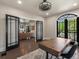 Office area featuring a hardwood floor, a desk, and black french doors at 4495 Utica St, Denver, CO 80212