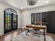 Home office featuring a desk, hardwood floors, and a decorative light fixture at 4495 Utica St, Denver, CO 80212