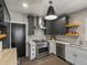 Modern kitchen featuring stainless steel appliances, gray cabinets, and bright white countertops at 4495 Utica St, Denver, CO 80212