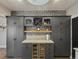Modern kitchen features dark cabinets, a wine fridge, and a marble countertop island at 4495 Utica St, Denver, CO 80212