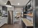 Bright, open kitchen with stainless steel appliances, dining area view, and modern cabinets at 4495 Utica St, Denver, CO 80212