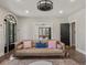Inviting living room featuring a sofa, hardwood floors, and a decorative light fixture at 4495 Utica St, Denver, CO 80212