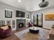 Bright living room with fireplace, built-in cabinets, and access to outdoor living at 4495 Utica St, Denver, CO 80212