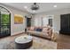 Inviting living room boasting a decorative light fixture, hardwood floors, and large window at 4495 Utica St, Denver, CO 80212