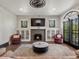 Bright living room featuring a fireplace, built-in cabinets, and comfortable seating at 4495 Utica St, Denver, CO 80212