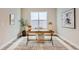 Bright home office space featuring a decorative rug, desk, and window at 119 Leafy Aster Ln, Castle Rock, CO 80104