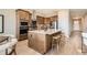 Modern kitchen with stainless steel appliances and a large center island with seating at 119 Leafy Aster Ln, Castle Rock, CO 80104