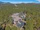 Aerial view of a secluded home surrounded by lush greenery and a private driveway at 2817 Keystone Dr, Evergreen, CO 80439