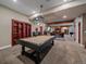 Finished basement boasts a pool table, custom cabinetry, and a partial view into another room at 2817 Keystone Dr, Evergreen, CO 80439