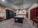 Basement game room featuring a pool table, arcade game, and unique vintage decor at 2817 Keystone Dr, Evergreen, CO 80439