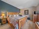 Comfortable bedroom with a decorative wooden bed frame and floral patterned bedding at 2817 Keystone Dr, Evergreen, CO 80439