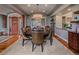 Formal dining room featuring a round table, chandelier, and large windows for natural light at 2817 Keystone Dr, Evergreen, CO 80439