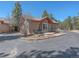 Charming home with a tiled roof, stone accents, and an outdoor patio perfect for relaxing at 2817 Keystone Dr, Evergreen, CO 80439