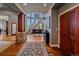 Elegant foyer with a staircase, hardwood floors, and large windows offering scenic views at 2817 Keystone Dr, Evergreen, CO 80439