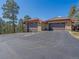 Attached three-car garage with an asphalt drive and views of mature trees at 2817 Keystone Dr, Evergreen, CO 80439