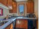 Functional kitchenette with wooden cabinets, sleek countertops, and modern appliances at 2817 Keystone Dr, Evergreen, CO 80439