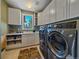 Functional laundry room featuring modern washer and dryer and lots of cabinet space at 2817 Keystone Dr, Evergreen, CO 80439