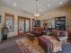 Inviting living room featuring warm lighting, comfortable seating, and access to an outdoor patio at 2817 Keystone Dr, Evergreen, CO 80439