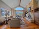 Cozy living room with a stone fireplace, hardwood floors, and scenic mountain views at 2817 Keystone Dr, Evergreen, CO 80439