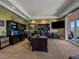 Spacious home office features custom built-ins, large desk, recessed lights and patio access at 2817 Keystone Dr, Evergreen, CO 80439