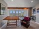 Comfortable sitting area featuring a cozy chair, desk, and scenic mountain views at 2817 Keystone Dr, Evergreen, CO 80439