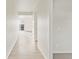 Bright hallway featuring sleek flooring leading to a light-filled room with a sliding glass door at 1918 S Coolidge Way, Aurora, CO 80018