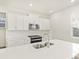 Modern white kitchen featuring an island, stainless steel appliances, and sleek countertops at 1918 S Coolidge Way, Aurora, CO 80018