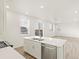 Modern white kitchen featuring an island, stainless steel appliances, and sleek countertops at 1918 S Coolidge Way, Aurora, CO 80018