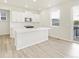 Modern white kitchen featuring an island, stainless steel appliances, and sleek countertops at 1918 S Coolidge Way, Aurora, CO 80018