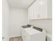 Bright laundry room featuring modern washer and dryer and white cabinetry for ample storage space at 1918 S Coolidge Way, Aurora, CO 80018