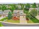Aerial view of home with a three car garage, lush landscaping, and well manicured lawn at 8646 Fawnwood Dr, Castle Pines, CO 80108