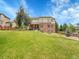 Backyard featuring lush lawn and mature trees, perfect for relaxing at 8646 Fawnwood Dr, Castle Pines, CO 80108