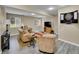 Cozy basement entertainment area with comfortable seating, dartboard, and a mounted flat screen TV at 8646 Fawnwood Dr, Castle Pines, CO 80108
