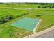 Outdoor green basketball court with hoops and benches on a sunny day at 8646 Fawnwood Dr, Castle Pines, CO 80108
