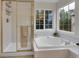 Bathroom featuring a shower and soaking tub near a window at 8646 Fawnwood Dr, Castle Pines, CO 80108