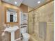 Finished basement bathroom with walk-in shower, sink, and linen cabinet at 8646 Fawnwood Dr, Castle Pines, CO 80108