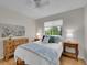 Bedroom featuring an artistic painting and a large window at 8646 Fawnwood Dr, Castle Pines, CO 80108
