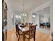 Elegant dining room features a wood table, chandelier, and windows with bright natural light at 8646 Fawnwood Dr, Castle Pines, CO 80108