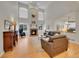 Spacious living room with a fireplace, a two-story ceiling, and large windows at 8646 Fawnwood Dr, Castle Pines, CO 80108