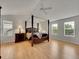 Spacious main bedroom with a four-poster bed, hardwood floors, and multiple windows at 8646 Fawnwood Dr, Castle Pines, CO 80108