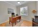 Well-lit office with hardwood floors, a large desk, and a view from the window at 8646 Fawnwood Dr, Castle Pines, CO 80108