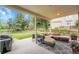 Covered patio with an outdoor seating area, overlooking a fenced backyard at 8646 Fawnwood Dr, Castle Pines, CO 80108