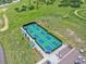Aerial view of multiple blue and green pickleball courts with players in a grassy area at 8646 Fawnwood Dr, Castle Pines, CO 80108