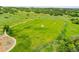 Aerial view of a green soccer field with nets and a small playground at 8646 Fawnwood Dr, Castle Pines, CO 80108